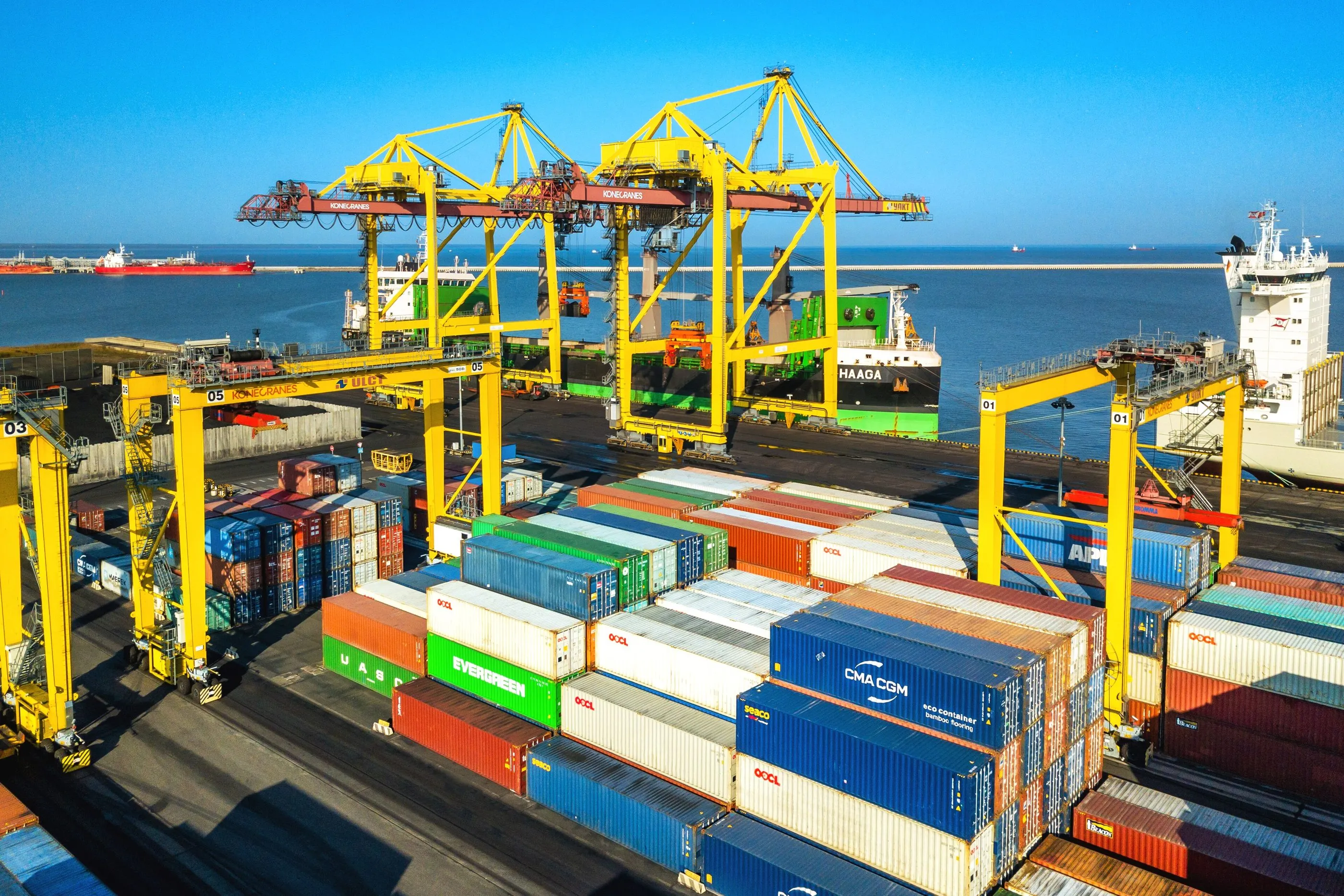 Gantry cranes over stacked containers at a port on the Baltic.